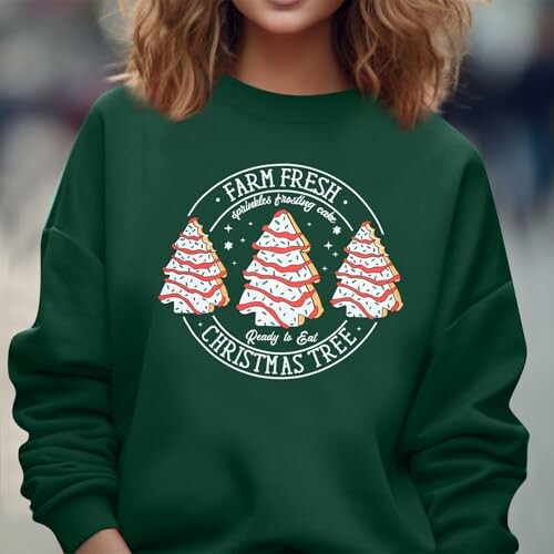 Green sweater with Christmas tree design and festive text