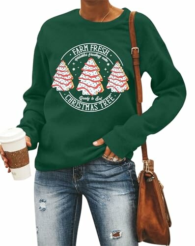 Person wearing green Christmas sweater with tree design