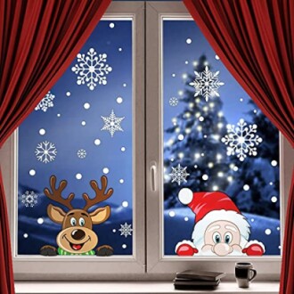 A festive window decorated with Santa and reindeer decorations