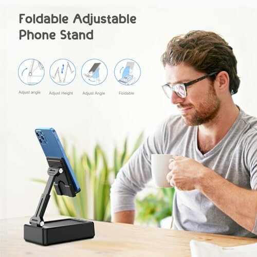 Man using a foldable adjustable phone stand on a table.