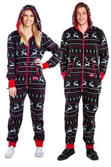 Two people wearing matching holiday-themed onesies with reindeer patterns.