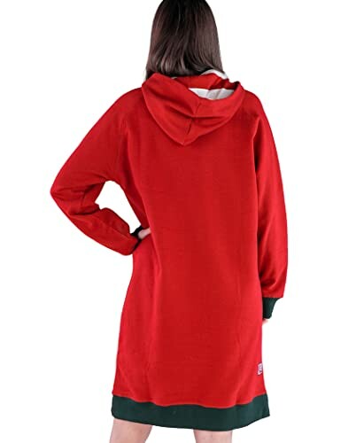 Person wearing a red hooded blanket with green cuffs