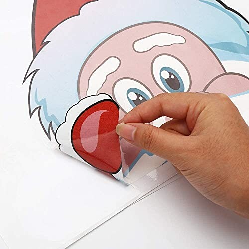 Hand peeling off a Santa Claus sticker for decoration