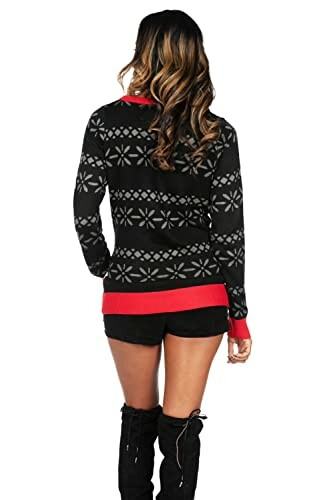 Woman in a black snowflake sweater with red accents